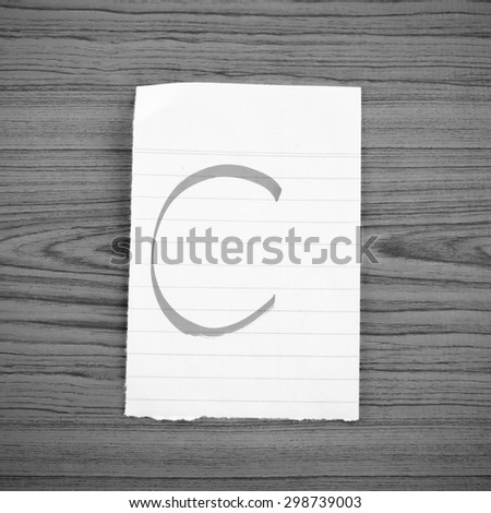 grade c on wood wall background black and white color tone style
