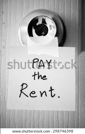 sticky note write a message pay the rent on the latch door black and white color tone style