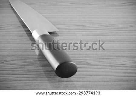 kitchen knife on wood table background black and white color tone style