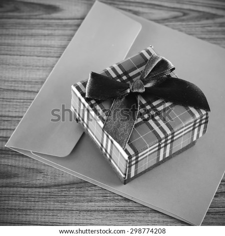 gift box and envelope on wood background black and white color tone style