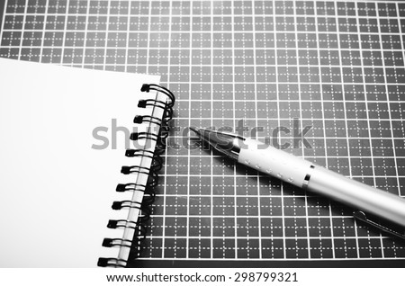 notebook and pen on green cutting mat black and white color tone style