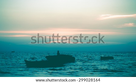 beautiful natural background the sun sets with clounds and black Silhouette boat on sea blurry vintage style