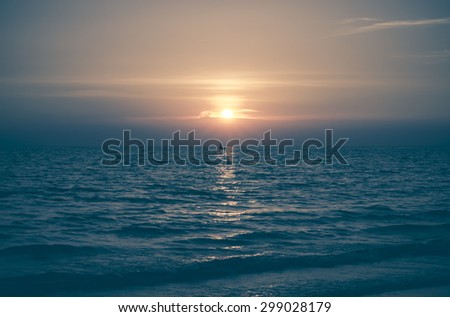 Yellow Sun Set in The Middle of The Ocean and very very small boat blurry vintage style