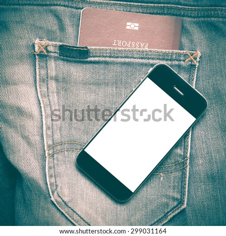 passport in jean pocket with smart phone retro vintage style