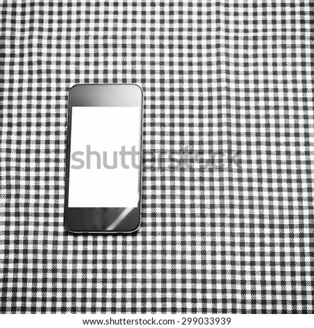 smart phone on kitchen towel background black and white color tone style