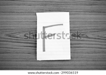grade f on wood wall background black and white color tone style
