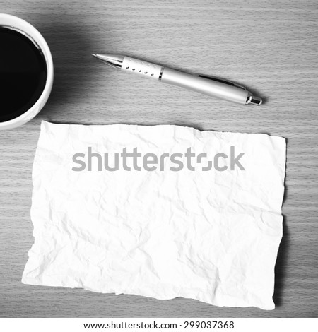 paper and pen with coffee cup on wood background black and white color tone style
