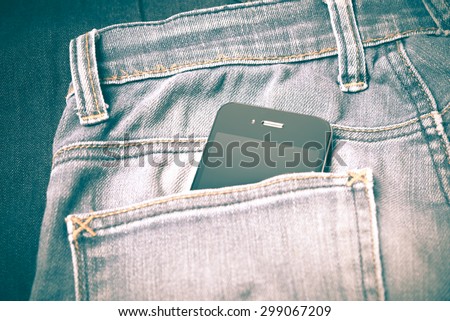 smart phone in jean pocket pants retro vintage style
