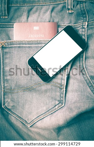 passport in jean pocket with smart phone retro vintage style