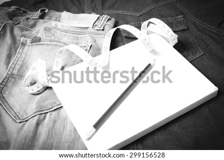 measuring tape and notebook with jean black and white tone color style