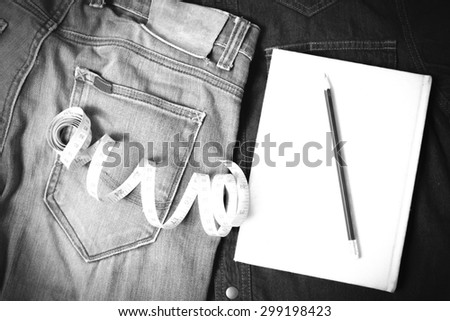 measuring tape and notebook with jean black and white tone color style