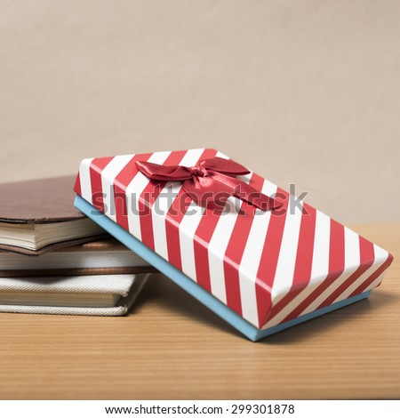 book with gift box on wood background