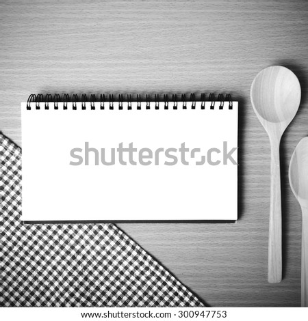 notebook and kitchen tools on table black and white color tone style