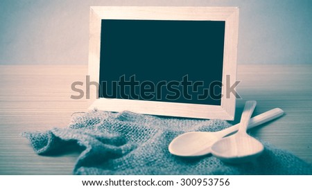 blackboard and wooden spoon on table vintage style