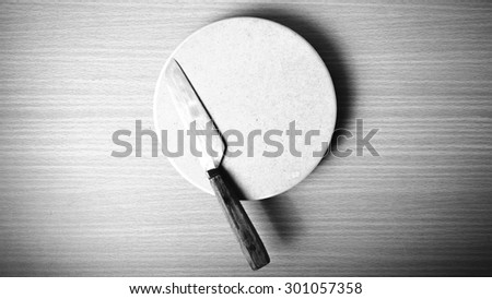 knife and cutting board on table black and white color tone style