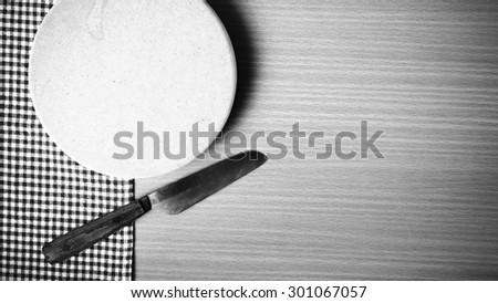 knife and cutting board on table black and white color tone style