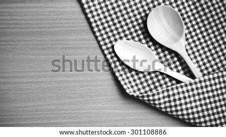 wood spoon and kitchen towel on table black and white color tone style