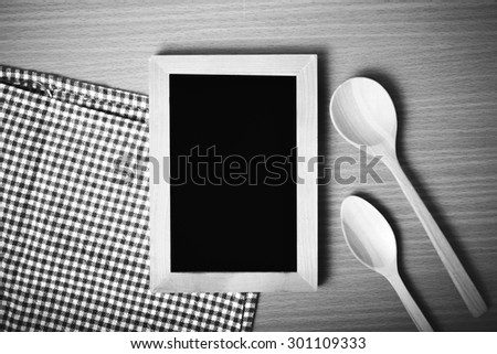 blackboard and wooden spoon on table black and white color tone style
