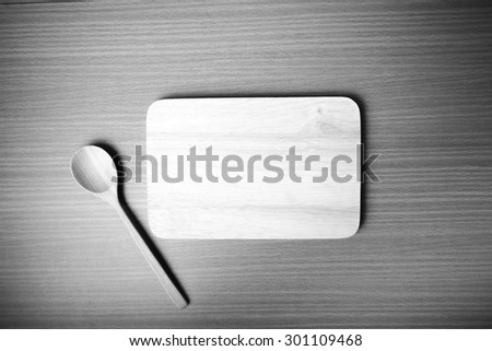 cutting board and wooden spoon on table black and white color tone style
