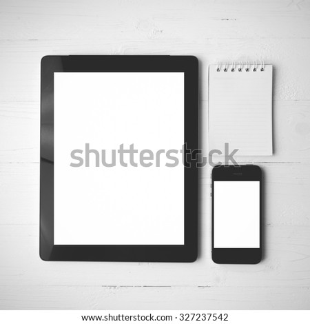 tablet and cellphone over white table black and white color style