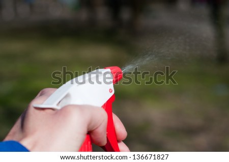 sprinkling water sprayer in hand