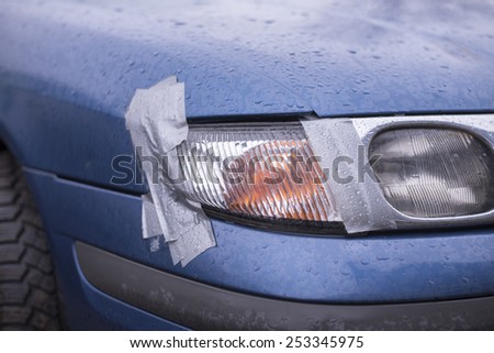 Car accident, insurance concept with adhesive tape on lights