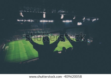 blurred fans on football stadium, vintage effect