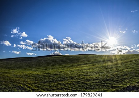 Beautiful HDR landscape at the sun, shining over the valley,