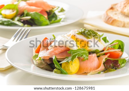 Poached egg salad with smoked salmon, cherry tomatoes and pesto.
