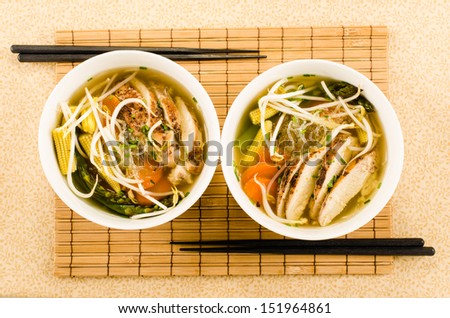 asian chicken noodle soup with glass noodles, bean sprouts and vegetables