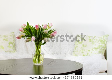 vase of tulips in modern white living room - home decor