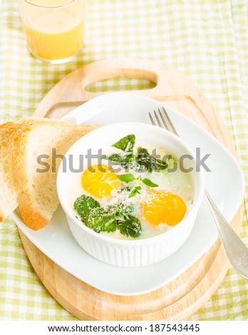 Baked eggs with spinach on white with toast