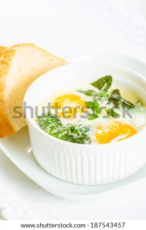 Baked eggs with spinach on white with toast