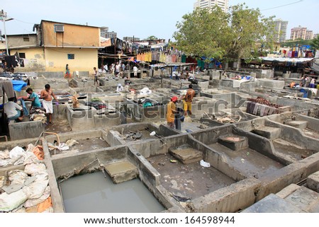 Mumbai, India - October 27, 2011: Dhobi Ghat is a well known open air laundromat in Mumbai, India. The washers work in the open to wash the clothes from Mumbai\'s hotels and hospitals.