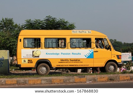 Pune, India - October 22, 2011: School Bus in Pune city. Children from poor families travel to school as their parents can\'t afford to keep them in the school.