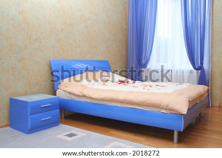 Blue bed in interior of bedroom