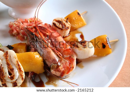 Sea food on grill detail with sauce and vegetable