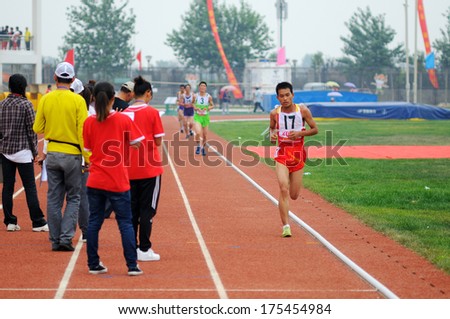 Xingtai City, Hebei Province, China - June 2012: On June 1, 2012 Chinese University Games, in the men\'s 10,000 m race, the athletes worked hard on the runway.