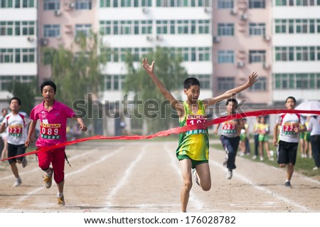 Baixiang County, Hebei Province, China - May 10, 2013. Baixiang County Middle School Track Meet held in May 10, 2013. Student athletes worked hard toward the finish line.