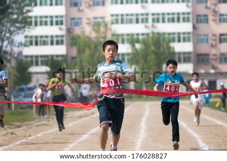 Baixiang County, Hebei Province, China - May 10, 2013. Baixiang County Middle School Track Meet Held In May 10, 2013. Student Athletes Worked Hard Toward The Finish Line.