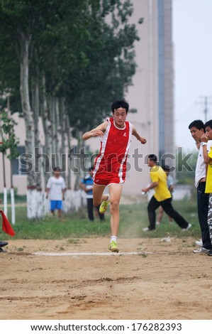 BAIXIANG COUNTY, HEBEI PROVINCE, CHINA - MAY 2012: On May 11, 2012 baixiang County Middle School Track and Field Games, student athletes performance in the long jump competition is very exciting.
