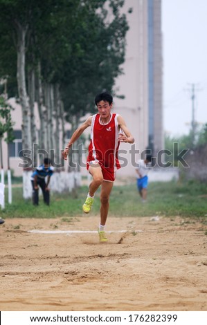 BAIXIANG COUNTY, HEBEI PROVINCE, CHINA - MAY 2013: On May 11, 2012 baixiang County Middle School Track and Field Games, student athletes performance in the long jump competition is very exciting.