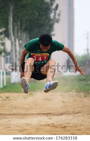 BAIXIANG COUNTY, HEBEI PROVINCE, CHINA - MAY 20132012: On May 11, 2012 baixiang County Middle School Track and Field Games, student athletes performance in the long jump competition is very exciting.