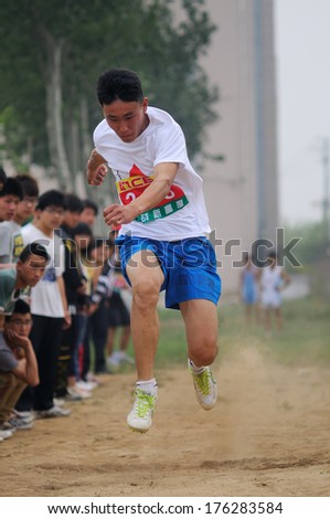 BAIXIANG COUNTY, HEBEI PROVINCE, CHINA - MAY 2012: On May 11, 2012 baixiang County Middle School Track and Field Games, student athletes performance in the long jump competition is very exciting.