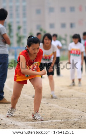 BAIXIANG COUNTY, HEBEI PROVINCE, CHINA - MAY 2013: Baixiang County Middle School Track Meet held in May 10, 2013. Student athletes in sprint moment of starting the project.