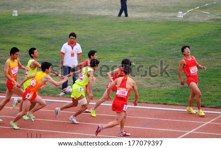 XINGTAI CITY, HEBEI PROVINCE, CHINA - June 2012: On June 1, 2012 Chinese University Games, four by one hundred in the game, players competitive, boldly, very exciting.