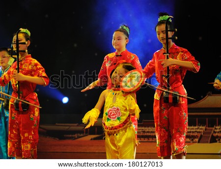 SHIJIAZHUANG CITY, CHINA - JULY 7: On July 7, 2012 in Shijiazhuang City, China Youth Arts Festival Unidentified group of cute kids performing  Chinese folk instrumental ensemble.
