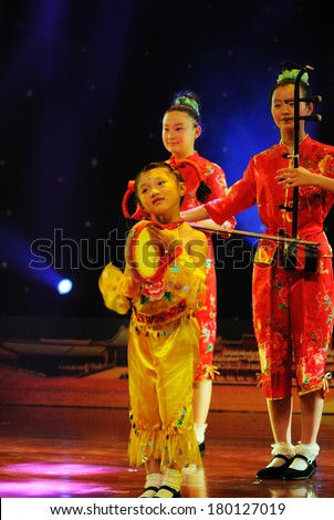 SHIJIAZHUANG CITY, CHINA - JULY 7: On July 7, 2012 in Shijiazhuang City, China Youth Arts Festival Unidentified group of cute kids performing  Chinese folk instrumental ensemble.