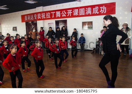 BAIXIANG,CHINA -JAN 15, 2014, Baixiang County Youth Center has invited foreign teachers to teach Latin dance. Unidentified teachers and students happy in the enjoyment of learning.