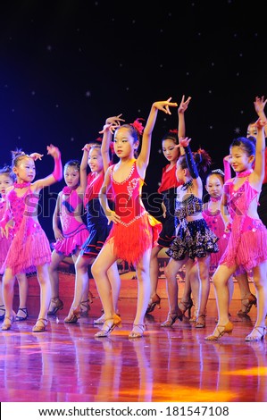SHIJIAZHUANG CITY, CHINA - JULY 7: On July 7, 2012 in Shijiazhuang City, China Youth Arts Festival Unidentified group of cute kids performing  Unrestrained rumba dance.